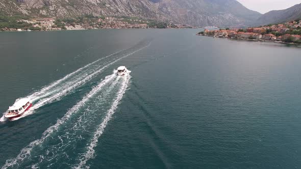 Boats Sail Along the Bay Along the Coast of Prcanj