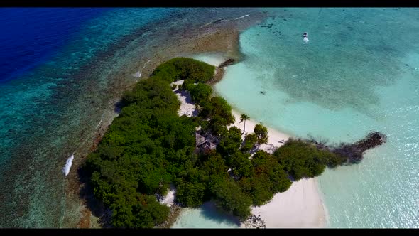 Aerial drone view scenery of tranquil island beach voyage by aqua blue sea with white sand backgroun