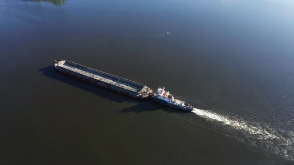 Big River Barge Floats Along the River  Drone Aerial Orbit Shot