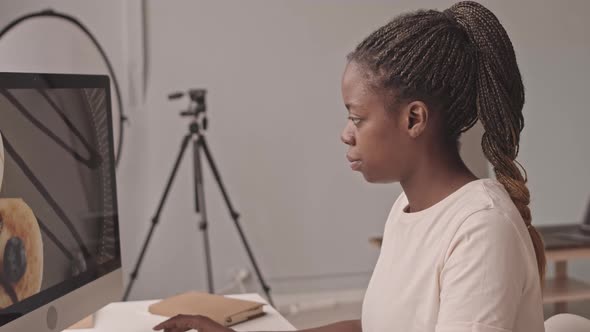 Portrait of African-American Female Photographer at Work