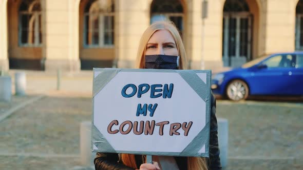 Young Woman Calling to Open the Country on Protest Walk
