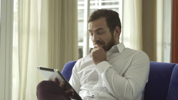 Man using digital tablet and credit card to make a purchase online