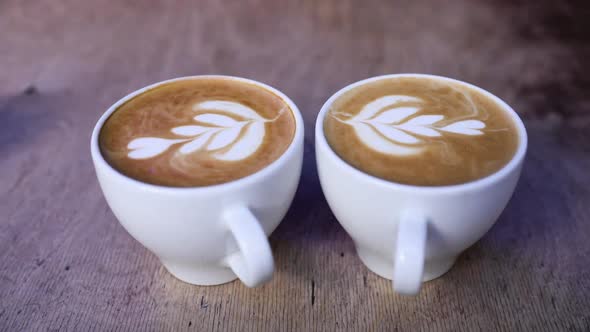 Coffee Cups With Latte Art On Table In Cafe Closeup