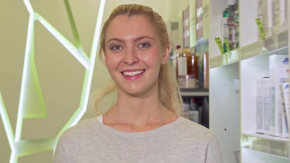 Happy Healthy Woman Showing Thumbs Up, Holding Blister of Pills at Drugstore