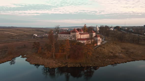 Aerial Drone Shot of Historic Castle on Hill Near Lake Medieval Architecture and Cultural Landmark