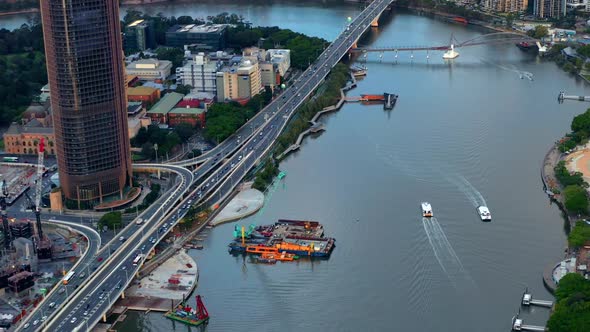 CityCat Cruising In The Brisbane River With Traffic On Pacific Motorway In Brisbane, QLD, Australia.