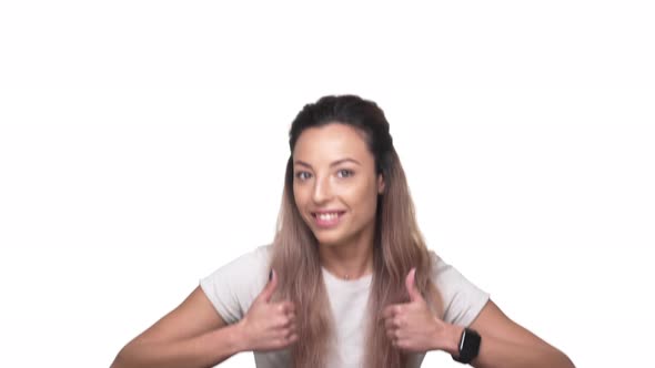 Portrait of Optimistic Woman with Dyed Hair Appearing on Camera with Thumbs Up and Smile Over White