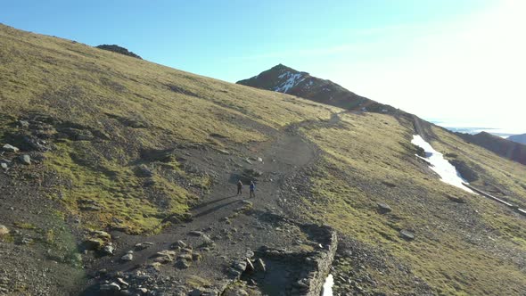 Aerial view of people hiking and climbing Snowdon mount in Wales on a sunny d