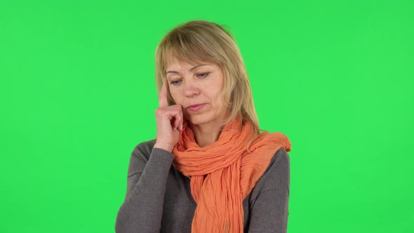 Portrait of Middle Aged Blonde Woman Is Thinking About Something, and Then an Idea Coming To Her