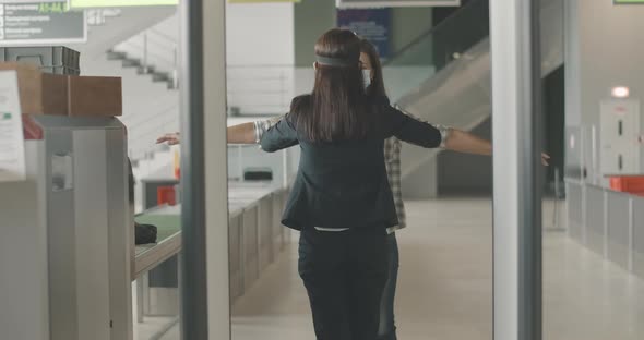 Physical Inspection of Female Tourist at Airport Checkpoint. Employee Checking Young Caucasian Woman