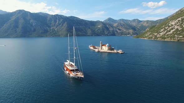 Sailing Yacht Sails Past the Island of Gospa Od Skrpjela