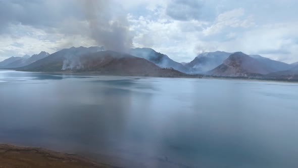 Drone camera captured haze shrouded the hills after a wildfire near the Jackson Lake, Wyoming, USA