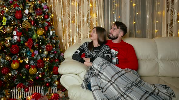 Young Mixed Couple Enjoying Christmas Tree