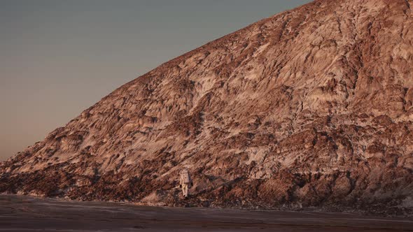 an Astronaut at the Foot of the Hill Takes the First Steps Towards Climbing It