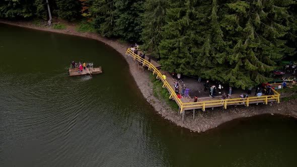 Aerial View of Synevyr Lake Piers with Tourists