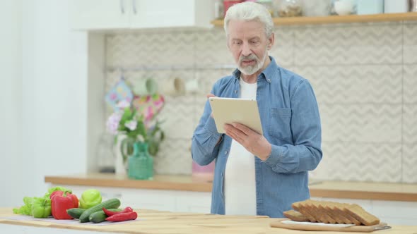 Loving Old Man Doing Video Call On Tablet in Kitchen