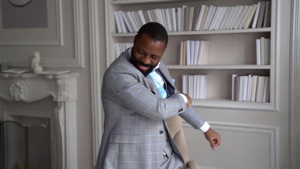Cheerful African-American with a Beard, in a Stylish Gray Suit. The Businessman