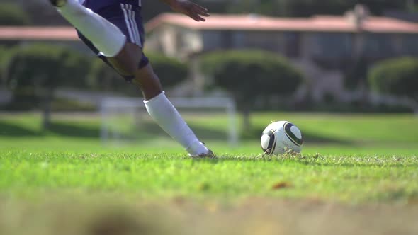 A man playing soccer on a grassy field