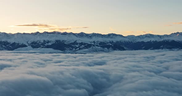 Aerial View of Mountain Ranges in Winter Above the Sky