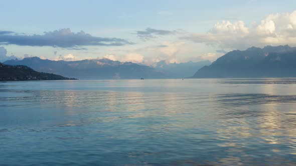 Flying low over Lake Léman with sunset light over the Alps in the background, waves and reflections