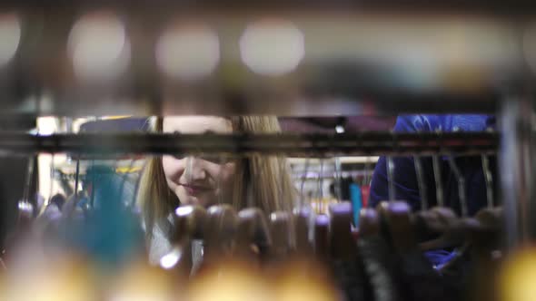 Girl looking through hangers alt