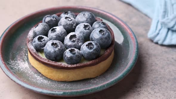 Tartlet with blueberries, chocolate and cream cheese.