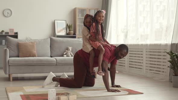 Man Riding Little Daughters on Back