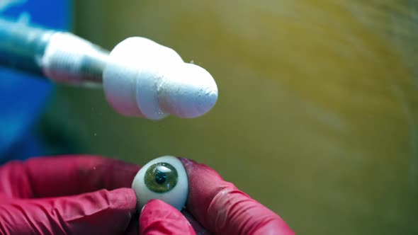 Polishing the eye prosthesis.