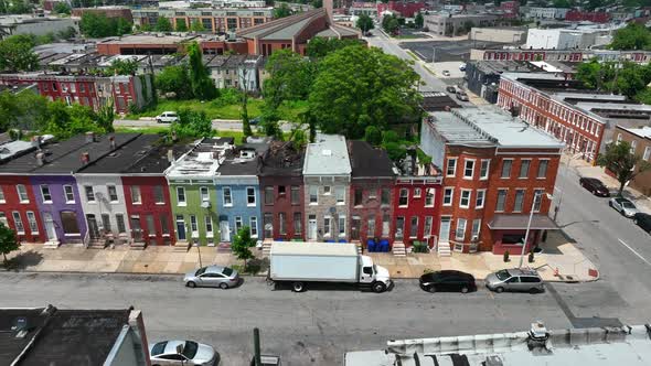 Low income housing in USA. Colorful rowhomes in America. Inner city living, summer aerial truck shot