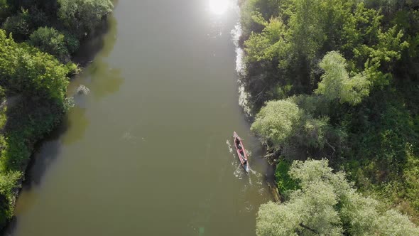 An Aerial View. Two in a Kayak, Merging on the Amazon. The River and the Banks Are Overgrown with