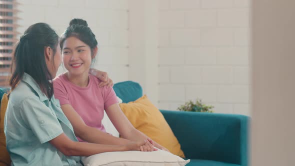 Young Lesbian lgbtq Asian women couple hug and kiss at home.