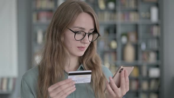 Portrait of Young Woman Using Credit Card on Smartphone