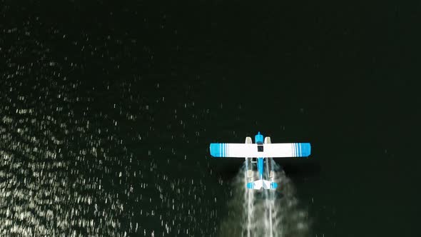 Aerial top down, seaplane taking off from lake water surface. Balsam Lake, Wisconsin