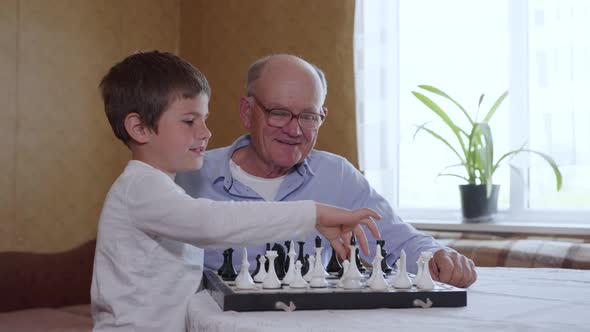 Relationship with Children, Elderly Sympathetic Grandfather in Glasses for Sight Plays with Smart