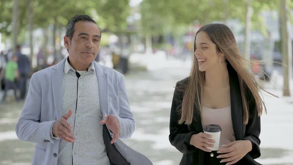 Male and Female Colleagues Talking Outdoor