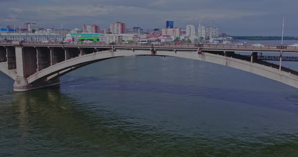 Cars Move Across the Bridge of a Wide River