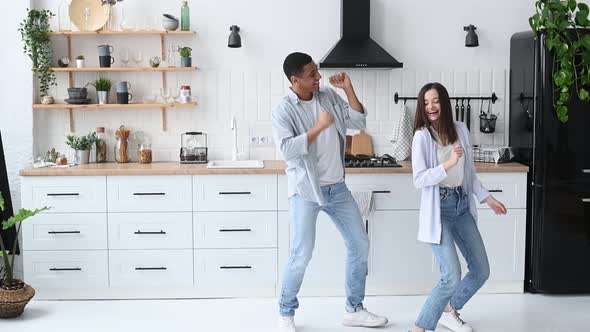 A Young Modern Happy Couple in Love Newlyweds Stylishly Dressed Dance Together to Their Favorite