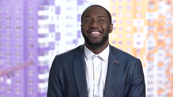 Satisfied Afro-american Businessman on Blurred Background.