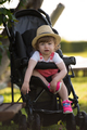 baby girl sitting in the baby stroller - PhotoDune Item for Sale