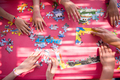 top view of kids hands playing with puzzles - PhotoDune Item for Sale