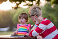 mom and her little daughter using tablet computer - PhotoDune Item for Sale