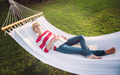 woman reading a book while relaxing on hammock - PhotoDune Item for Sale