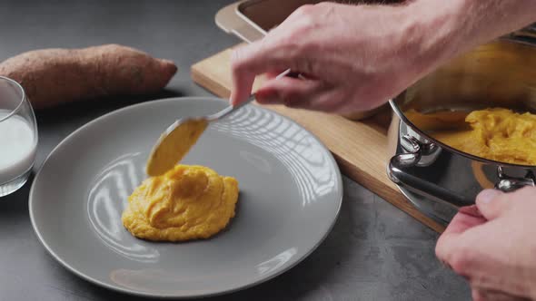 Serving delicious mashed sweet potato with coconut milk and roasted chicken leg. Clip represents hea