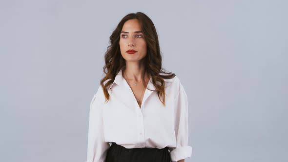 Brunette Female in White Shirt and Black Skirt is Looking at Her Watch and Screaming While Posing on