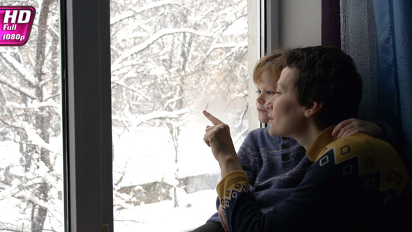 Family Admiring Christmas Snowfall