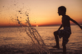 One happy little boy playing on the beach at the sunset time. - PhotoDune Item for Sale