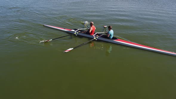 Senior caucasian man and woman rowing boat on a river