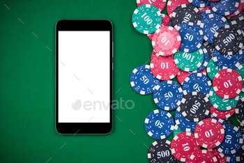 Mobile phone and casino chips on poker table