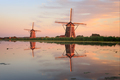 Two windmills with reflection at sunset - PhotoDune Item for Sale