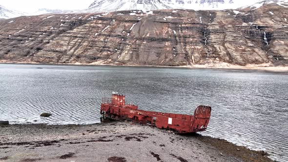 WWII US Navy LCM Ship Wreck In Mjoifjordur, Iceland - aerial pullback